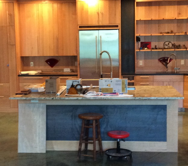 Interior kitchen detail of the Caldwell residence, featuring a custom wood island, modern cabinetry, and the warm, contemporary finish of the home.